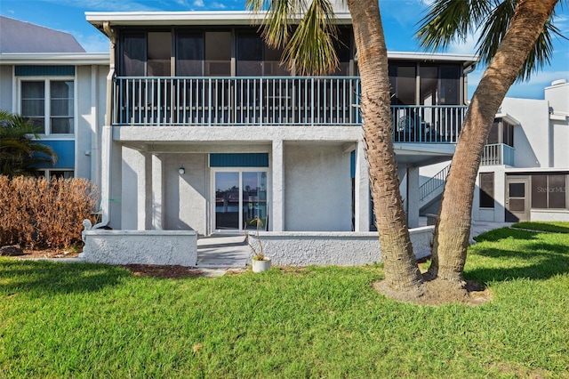 exterior space with a sunroom and a yard