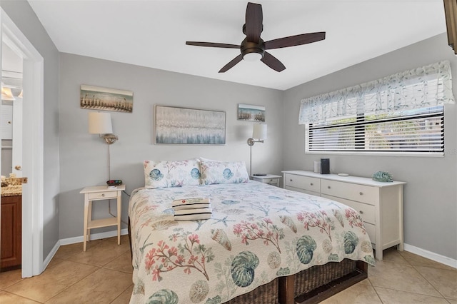 tiled bedroom featuring connected bathroom and ceiling fan