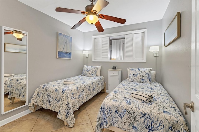 tiled bedroom featuring ceiling fan