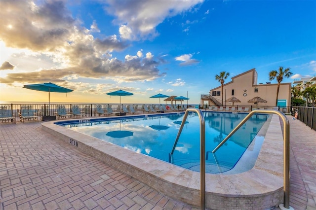 view of pool at dusk