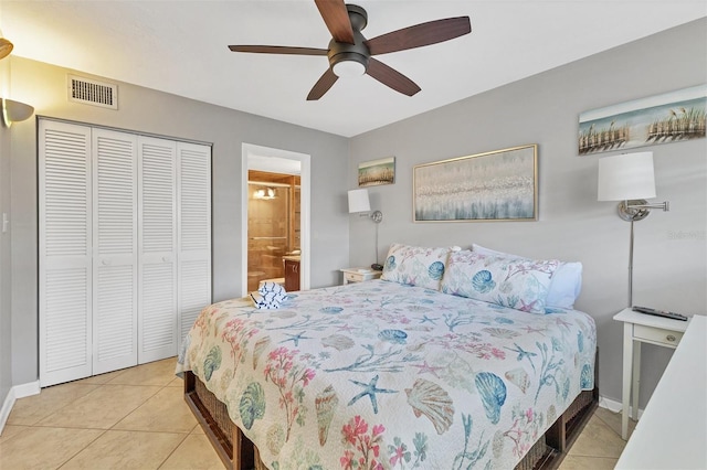 bedroom featuring light tile patterned flooring, ceiling fan, connected bathroom, and a closet