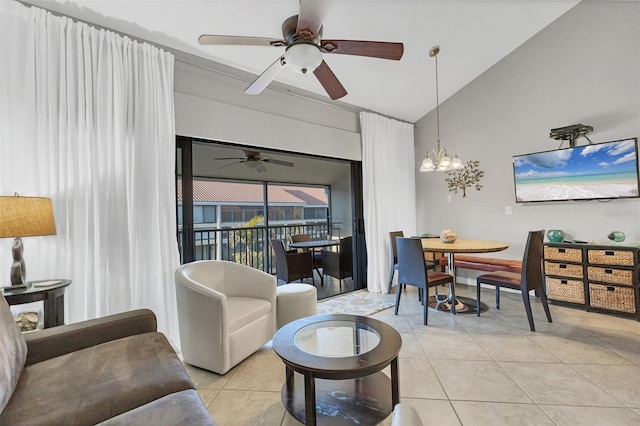 living room featuring lofted ceiling, light tile patterned floors, and ceiling fan with notable chandelier