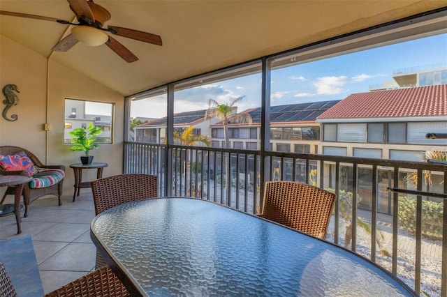 sunroom featuring vaulted ceiling and ceiling fan