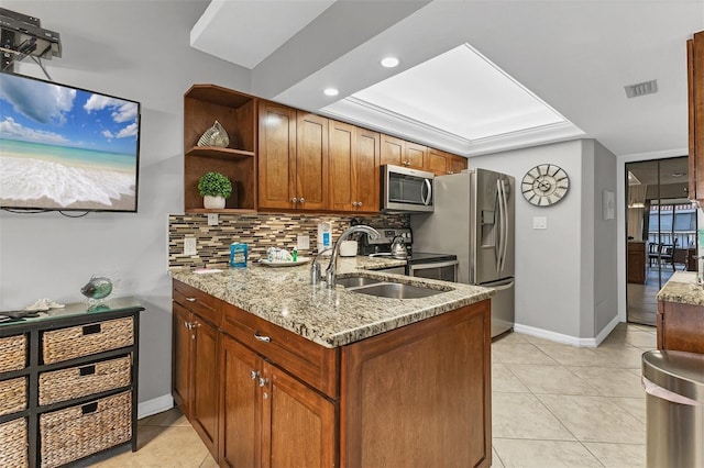 4621 Gulf Of Mexico Dr Unit D10, Longboat Key, FL 34228 - kitchen with appliances with stainless steel finishes, a tray ceiling, light stone countertops, open shelves, and backsplash
