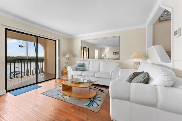 living room with hardwood / wood-style floors, a water view, and ornamental molding