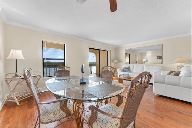 dining room with light hardwood / wood-style floors and ornamental molding