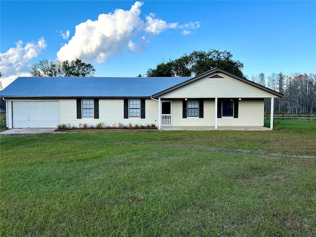 ranch-style house featuring a front yard, a porch, and a garage