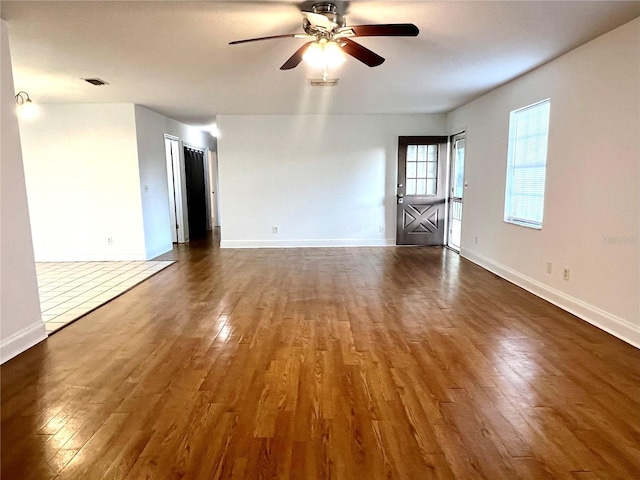 interior space with dark hardwood / wood-style flooring and ceiling fan