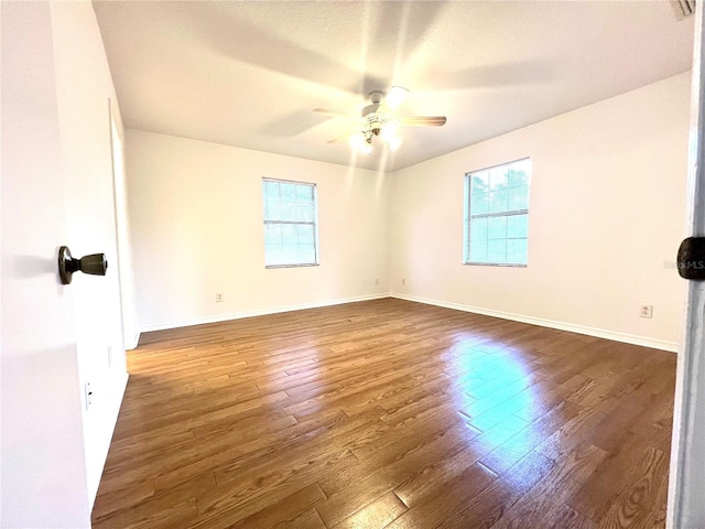 unfurnished room featuring ceiling fan and dark hardwood / wood-style flooring