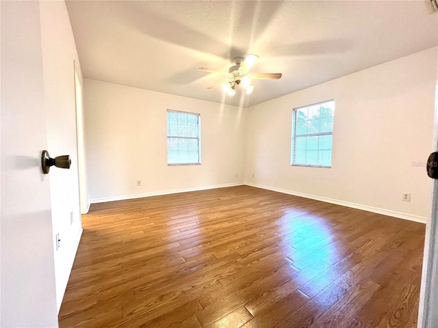 spare room featuring dark hardwood / wood-style floors and ceiling fan