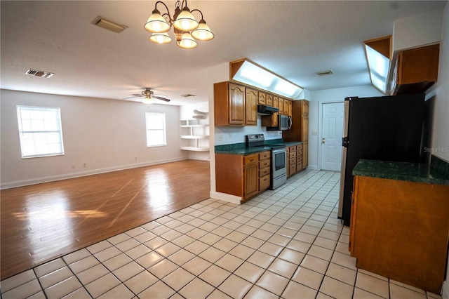 kitchen with refrigerator, a textured ceiling, ceiling fan with notable chandelier, light hardwood / wood-style flooring, and stainless steel electric range oven