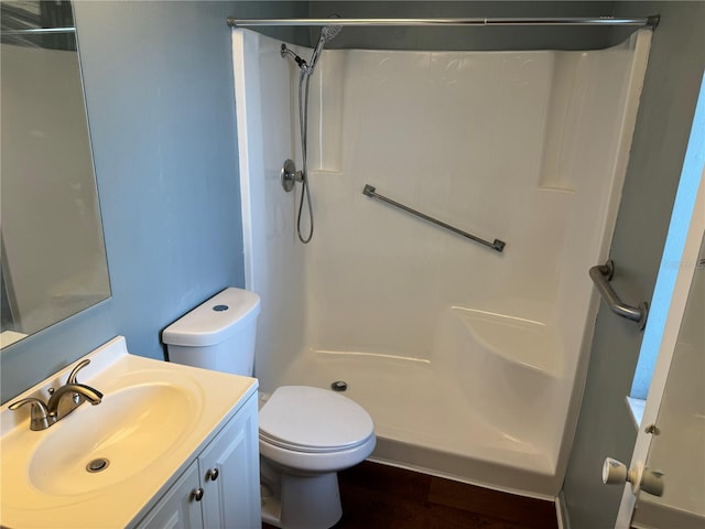 bathroom with vanity, hardwood / wood-style flooring, toilet, and walk in shower