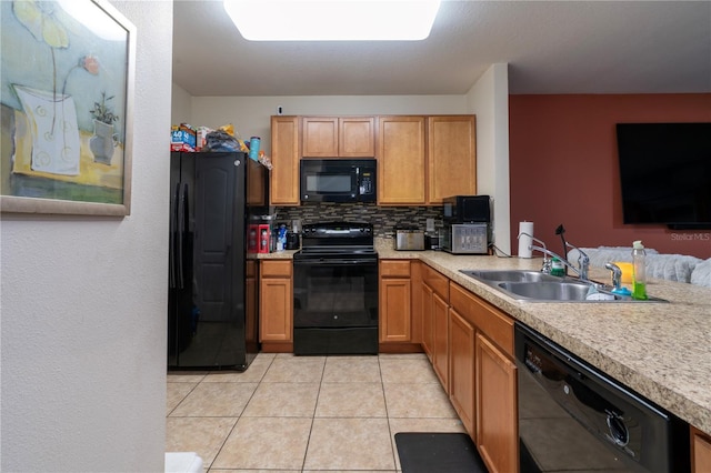 kitchen with light tile patterned floors, sink, backsplash, and black appliances