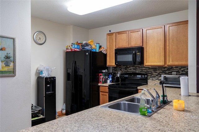 kitchen featuring decorative backsplash, sink, and black appliances