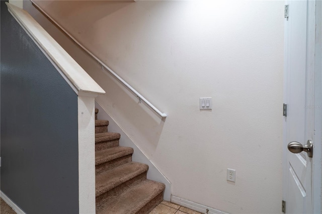 stairway featuring tile patterned flooring