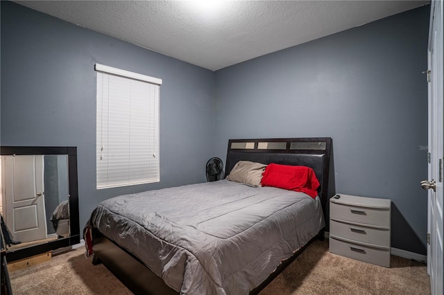 carpeted bedroom with a textured ceiling