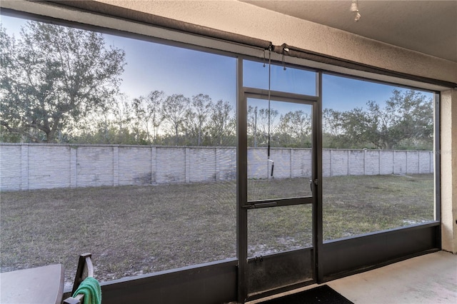 unfurnished sunroom featuring a water view