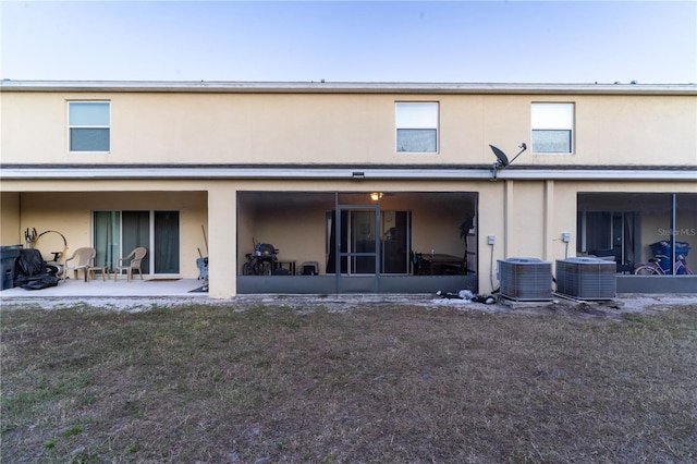 back of property featuring a patio and central AC