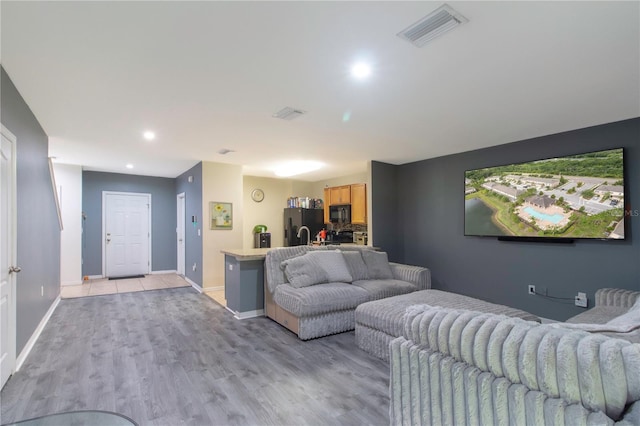 12827 Buffalo Run Dr, Gibsonton, FL 33534 - living room with light wood-type flooring, baseboards, and recessed lighting