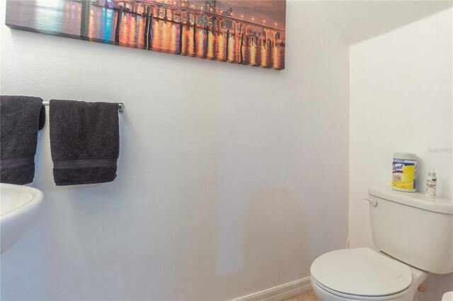 12827 Buffalo Run Dr, Gibsonton, FL 33534 - half bathroom featuring toilet and baseboards