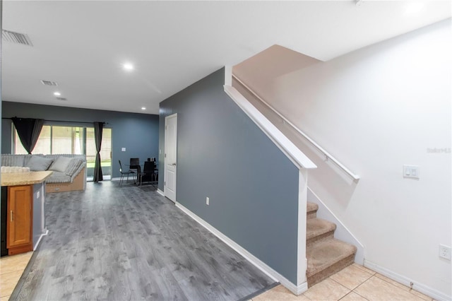 12827 Buffalo Run Dr, Gibsonton, FL 33534 - hallway featuring stairway, recessed lighting, light wood finished floors, and baseboards
