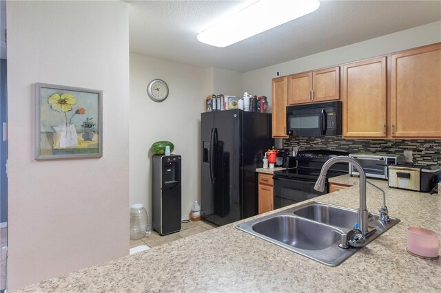 12827 Buffalo Run Dr, Gibsonton, FL 33534 - kitchen with black appliances, a sink, tasteful backsplash, light countertops, and light tile patterned flooring