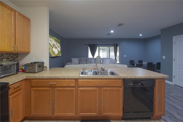 12827 Buffalo Run Dr, Gibsonton, FL 33534 - kitchen featuring black dishwasher, a sink, open floor plan, a peninsula, and recessed lighting