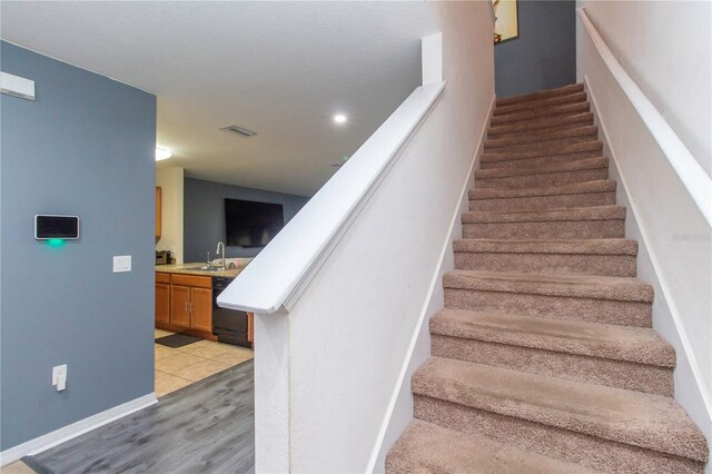 12827 Buffalo Run Dr, Gibsonton, FL 33534 - stairway with wood finished floors and baseboards