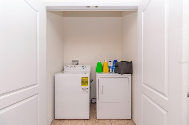 12827 Buffalo Run Dr, Gibsonton, FL 33534 - washroom with independent washer and dryer and light tile patterned floors