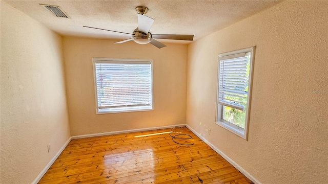 unfurnished room featuring wood-type flooring, a textured ceiling, and ceiling fan