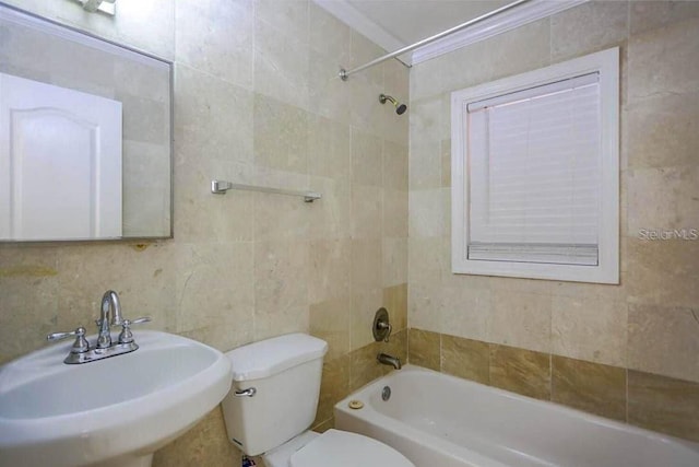 full bathroom with sink, ornamental molding, and tile walls