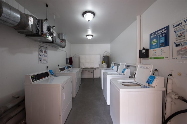 laundry area featuring water heater and independent washer and dryer