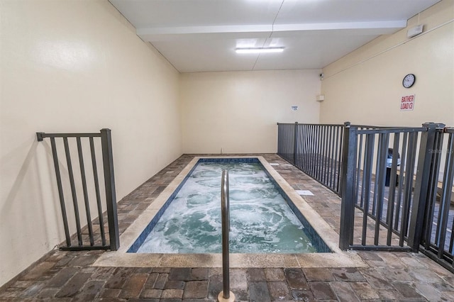 view of swimming pool with an indoor in ground hot tub