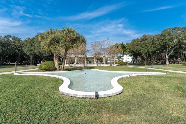 view of pool featuring a yard