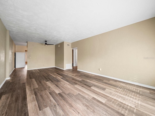 unfurnished room featuring wood-type flooring and a textured ceiling