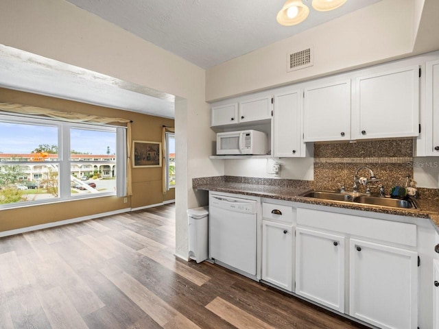 kitchen featuring a textured ceiling, white appliances, white cabinetry, and sink