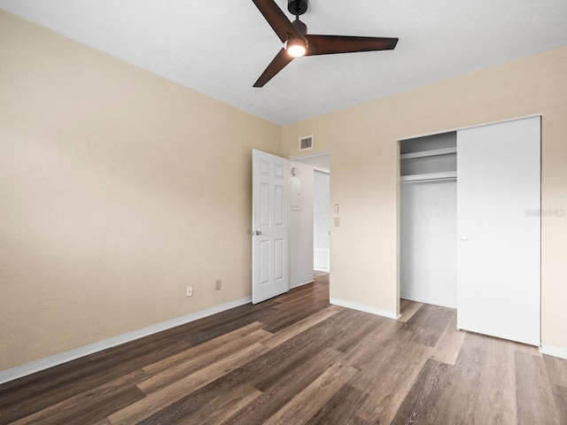 unfurnished bedroom with a closet, ceiling fan, and dark wood-type flooring