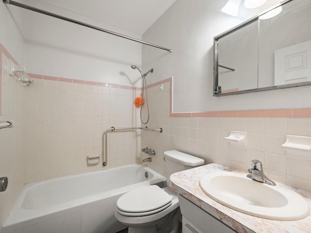 full bathroom with backsplash, vanity, tile walls, toilet, and tiled shower / bath