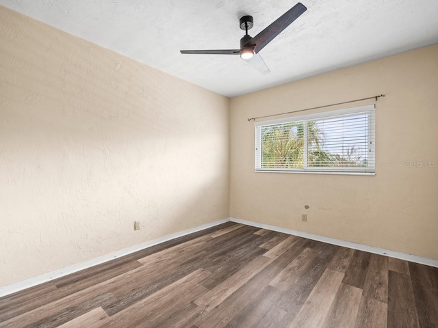 spare room featuring a textured ceiling, ceiling fan, and dark hardwood / wood-style floors