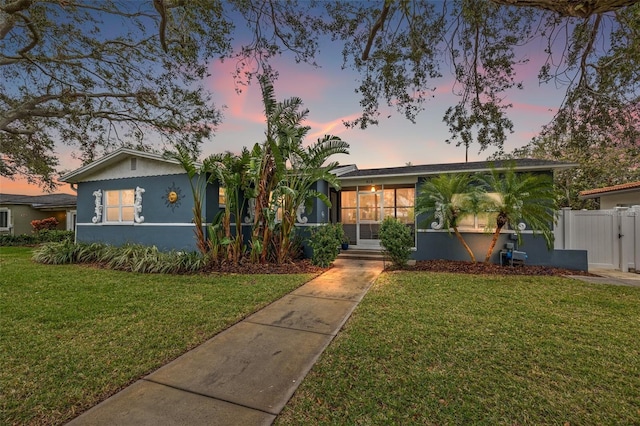 ranch-style house featuring a yard