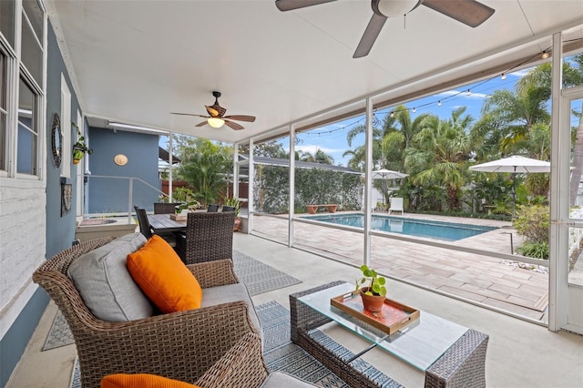 sunroom featuring ceiling fan