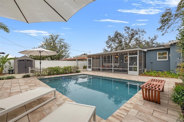 view of swimming pool featuring a sunroom and a patio