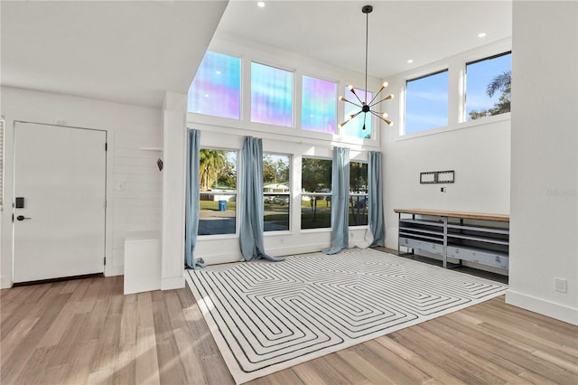 interior space featuring light wood-type flooring and an inviting chandelier