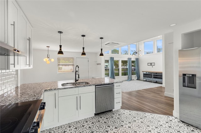 kitchen with hanging light fixtures, white cabinetry, sink, and appliances with stainless steel finishes