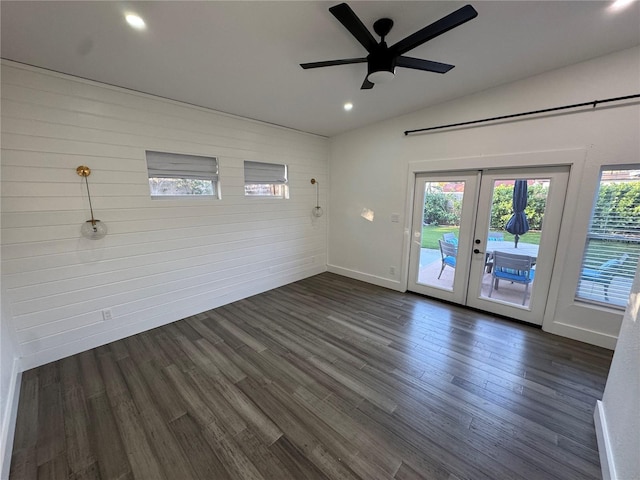 unfurnished room featuring ceiling fan, vaulted ceiling, dark wood-type flooring, and french doors