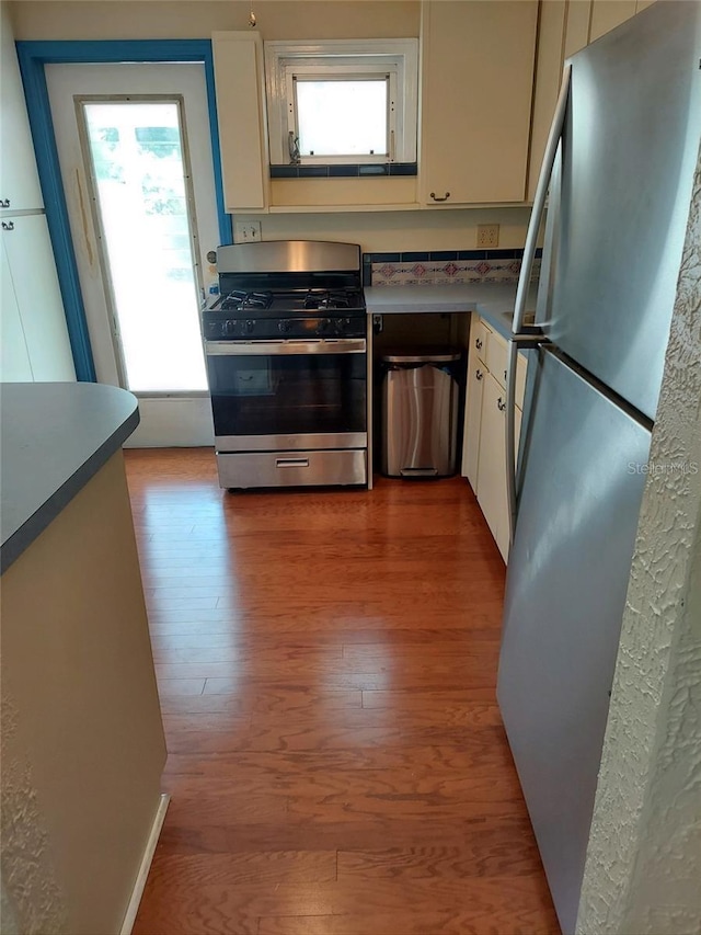 kitchen featuring light hardwood / wood-style flooring, stainless steel appliances, and white cabinetry