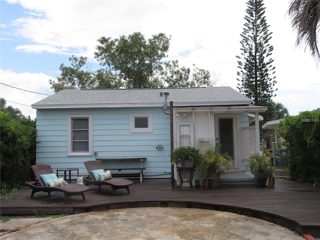 back of property with a wooden deck