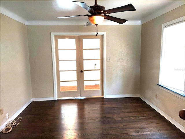 spare room with dark hardwood / wood-style flooring, french doors, and ceiling fan