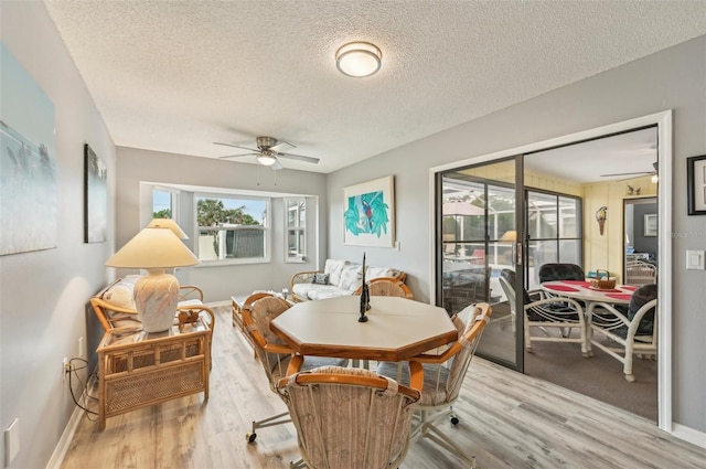 dining area featuring ceiling fan, a textured ceiling, and light hardwood / wood-style floors