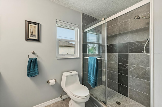 bathroom with toilet, tile patterned floors, a textured ceiling, and walk in shower